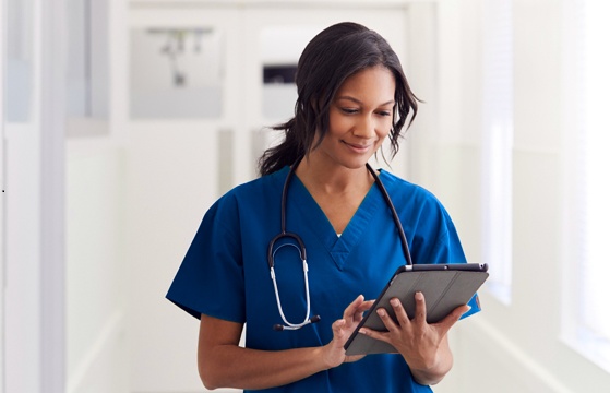 Doctor In Blue With Tablet